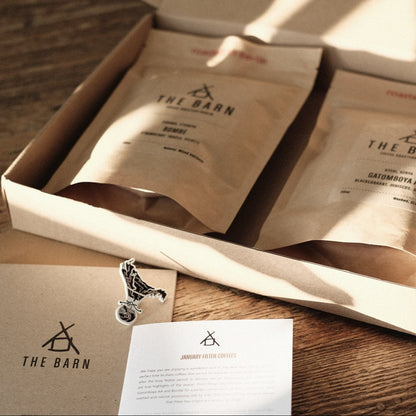 ROASTERS CHOICE SUBSCRIPTION coffee packaging with variety of beans and information card on wood table.