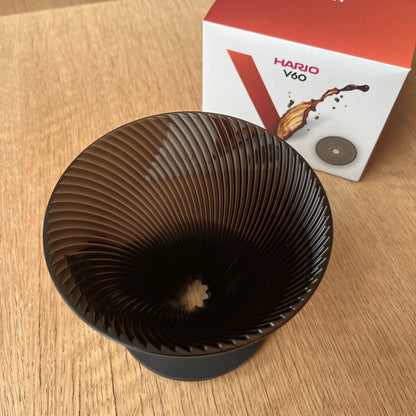 HARIO V60 NEO coffee dripper with unique ribbed design for optimal extraction on a wooden surface.