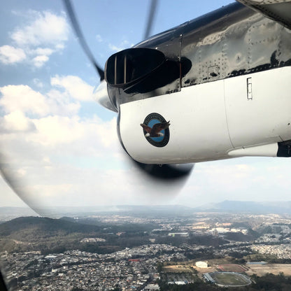 ATLAS COFFEE airplane propeller view over landscape during flight