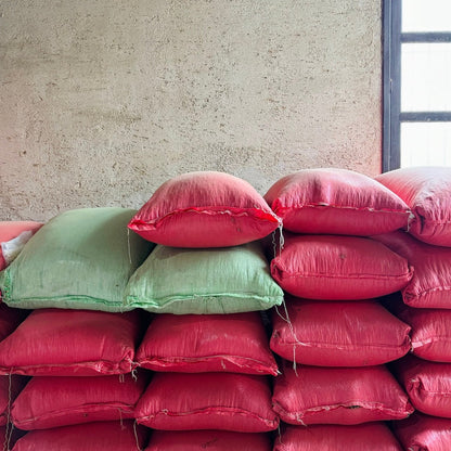 ATLAS COFFEE bags stacked, showcasing vibrant Guatemala Coffee Beans in colorful packaging.