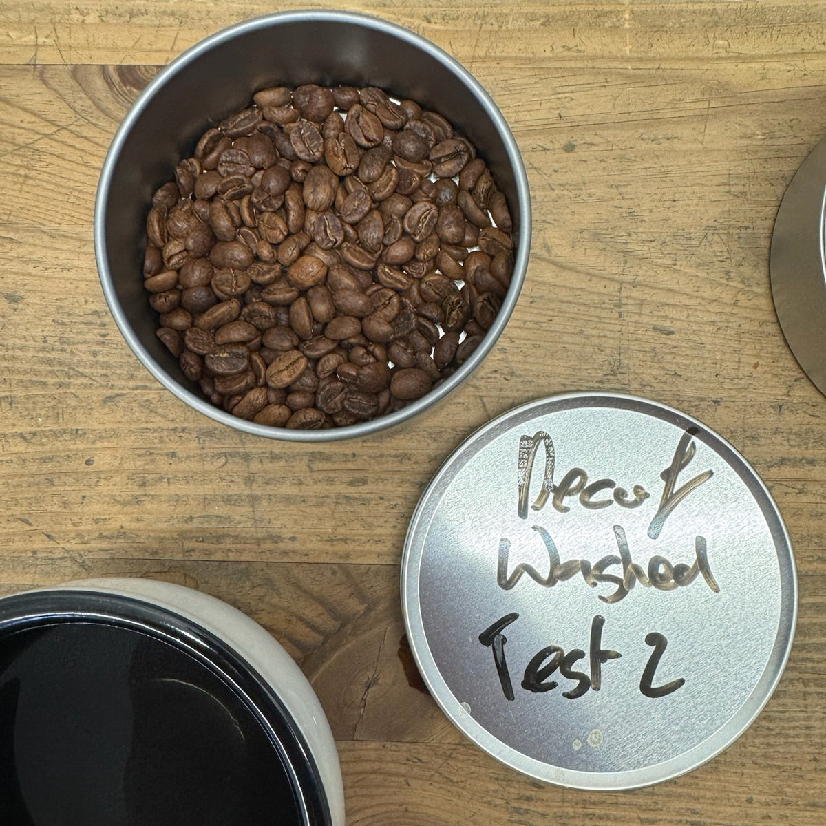 DECAF BALANCED coffee beans in a tin, showcasing rich flavors without caffeine.