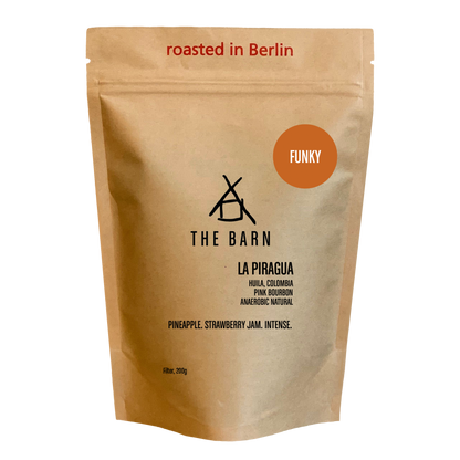 Kraft paper coffee bag with 'The Barn' branding and coffee details 'La Piragua' on a white background