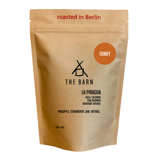 Kraft paper coffee bag with 'The Barn' branding and coffee details 'La Piragua' on a white background